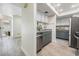 Well-lit kitchen with grey and white cabinets and stainless steel appliances at 103 E Davis Blvd # B, Tampa, FL 33606