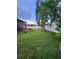 Spacious fenced backyard featuring a wooden hot tub and a large tree at 10539 Egret Haven Ln, Riverview, FL 33578