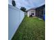 Fenced backyard featuring grassy lawn and partial view of the home's exterior at 10539 Egret Haven Ln, Riverview, FL 33578