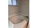 Bathroom tub with white tile surround and window at 10539 Egret Haven Ln, Riverview, FL 33578