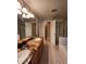 Bathroom features double sinks with granite countertops and a walk-in shower at 10539 Egret Haven Ln, Riverview, FL 33578