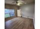 Bedroom features laminate flooring, ceiling fan, and a view of the backyard at 10539 Egret Haven Ln, Riverview, FL 33578