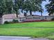 Welcome to South Pointe: A beautifully landscaped community entrance with vibrant flowers at 10539 Egret Haven Ln, Riverview, FL 33578