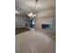 Dining area with elegant chandelier, large window, and access to backyard creates a welcoming ambiance at 10539 Egret Haven Ln, Riverview, FL 33578
