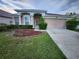 Charming single-story home featuring a well-manicured lawn and a two-car garage at 10539 Egret Haven Ln, Riverview, FL 33578