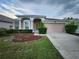 Charming single-story home featuring a well-maintained lawn and a two-car garage at 10539 Egret Haven Ln, Riverview, FL 33578