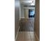 Hallway view of spacious living area with wood flooring and sliding glass doors to the outside at 10539 Egret Haven Ln, Riverview, FL 33578