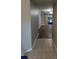 Hallway leading into a living room with sliding glass doors at 10539 Egret Haven Ln, Riverview, FL 33578