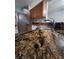 Kitchen with stainless sink, granite counters and wooden cabinetry offer function and style at 10539 Egret Haven Ln, Riverview, FL 33578