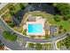 Aerial view featuring a community pool area with a lake, palm trees and parking at 10947 Brickside Ct, Riverview, FL 33579