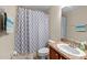 Standard bathroom with a shower/tub combo, neutral color scheme and single sink vanity at 10947 Brickside Ct, Riverview, FL 33579