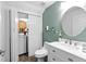 Well-lit bathroom featuring a modern vanity, toilet, and a convenient washer and dryer closet at 10947 Brickside Ct, Riverview, FL 33579