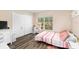 Well-lit bedroom with a large window and closet at 10947 Brickside Ct, Riverview, FL 33579