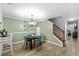 Bright dining area featuring modern chandelier and adjacent staircase at 10947 Brickside Ct, Riverview, FL 33579