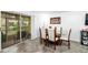 Bright dining area featuring a glass-topped table with modern chairs and sliding glass doors at 10947 Brickside Ct, Riverview, FL 33579