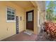 Inviting front entrance with a brick-paved porch, glass-paneled door, and cheerful welcome sign at 10947 Brickside Ct, Riverview, FL 33579