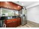 Kitchen with stainless steel refrigerator, granite countertops, and wood cabinets at 10947 Brickside Ct, Riverview, FL 33579