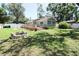 Expansive backyard featuring a wooden deck, privacy fence, and fire pit at 1103 E Lambright St, Tampa, FL 33604