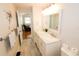 Renovated bathroom with dual sinks, and access to the living room at 1103 E Lambright St, Tampa, FL 33604