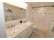 Bright bathroom featuring double sinks, white cabinets, and a shower/tub combo at 1103 E Lambright St, Tampa, FL 33604