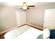 Cozy bedroom includes hardwood floors, a ceiling fan, and a closet at 1103 E Lambright St, Tampa, FL 33604