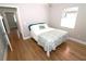 Inviting bedroom showcasing hardwood floors, a comfortable bed, and access to the hallway at 1103 E Lambright St, Tampa, FL 33604