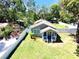 Aerial view of the home showcasing the well-maintained lawn and fenced-in yard at 1103 E Lambright St, Tampa, FL 33604