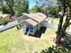 Aerial view of the home with a landscaped yard, deck, and mature trees at 1103 E Lambright St, Tampa, FL 33604