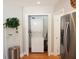 Convenient laundry closet with stacked washer and dryer unit next to the refrigerator at 1103 E Lambright St, Tampa, FL 33604