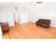 Open living room features hardwood floors, a ceiling fan, and multiple closet spaces at 1103 E Lambright St, Tampa, FL 33604