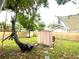 Well-maintained backyard features a shed, mature trees, and privacy fencing for outdoor activities at 111 12Th Ave, Indian Rocks Beach, FL 33785