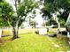 Fenced backyard oasis with mature trees providing shade, and outdoor seating; perfect for relaxation at 111 12Th Ave, Indian Rocks Beach, FL 33785