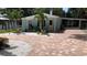 Charming single-story home with brick driveway and tropical landscaping at 111 12Th Ave, Indian Rocks Beach, FL 33785