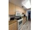 Well-lit kitchen featuring stainless steel appliances, wood cabinets, and stone countertops at 111 12Th Ave, Indian Rocks Beach, FL 33785