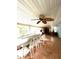 Spacious sunroom boasts tile flooring, a ceiling fan, and ample natural light, perfect for entertaining at 111 12Th Ave, Indian Rocks Beach, FL 33785