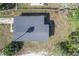 A bird's-eye view of the home showing the dark roof, yard, and surrounding greenery at 111 W Keyes Ave, Tampa, FL 33602