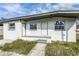 Single-story home with a simple entrance featuring a small porch and gray accents at 111 W Keyes Ave, Tampa, FL 33602