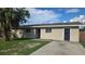 Charming single-story home with stucco siding, a well-manicured lawn, and mature tree at 1120 Union S St, St Petersburg, FL 33712