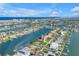 Aerial view of waterfront home featuring tropical landscaping and stunning bay views at 11240 6Th E St, Treasure Island, FL 33706