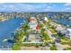Captivating waterfront home showcasing a dock and lush surroundings, with stunning scenic water views at 11240 6Th E St, Treasure Island, FL 33706