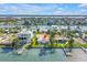 Waterfront property with a dock, lush landscaping, and scenic water vistas at 11240 6Th E St, Treasure Island, FL 33706