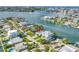 Waterfront home features lush landscaping, ample parking, dock access, and neighborhood water views at 11240 6Th E St, Treasure Island, FL 33706