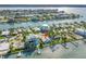 Waterfront residence boasts a private dock, green landscaping, outdoor pool, and peaceful water views at 11240 6Th E St, Treasure Island, FL 33706