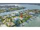 Waterfront property features a dock, lush landscaping, and views of the tranquil water and surrounding area at 11240 6Th E St, Treasure Island, FL 33706
