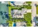 Overhead view of home showing roof, lawn, dock, seawall, and canal at 11240 6Th E St, Treasure Island, FL 33706