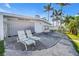 Backyard with lounge chairs and outdoor seating, perfect for relaxing and enjoying the outdoor space at 11240 6Th E St, Treasure Island, FL 33706