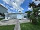 Backyard featuring a patio area with lounge chairs, providing a relaxed and inviting outdoor space at 11240 6Th E St, Treasure Island, FL 33706