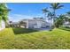 The backyard has lounge chairs, green grass, and a patio area at 11240 6Th E St, Treasure Island, FL 33706