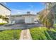 Charming backyard with mature trees, lounge chairs, and patio area at 11240 6Th E St, Treasure Island, FL 33706