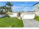 Charming home with well-manicured lawn, attached garage, and modern design at 11240 6Th E St, Treasure Island, FL 33706